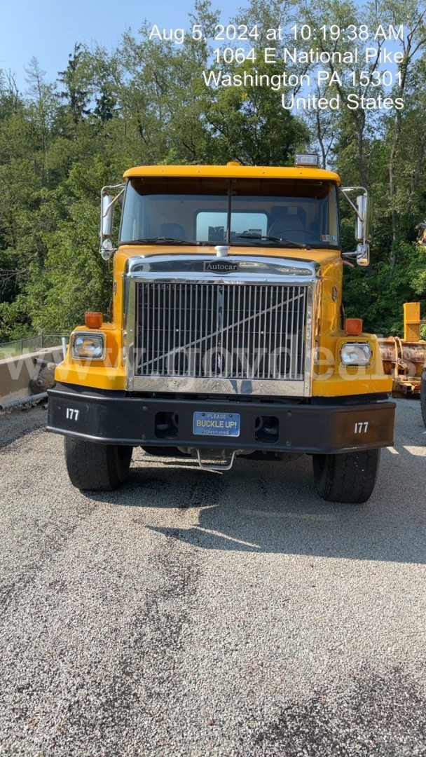 GMC ACL distributor truck front view showing large chrome grille and yellow cab, headlights, bumper, and VIN/stock watermark overlay.