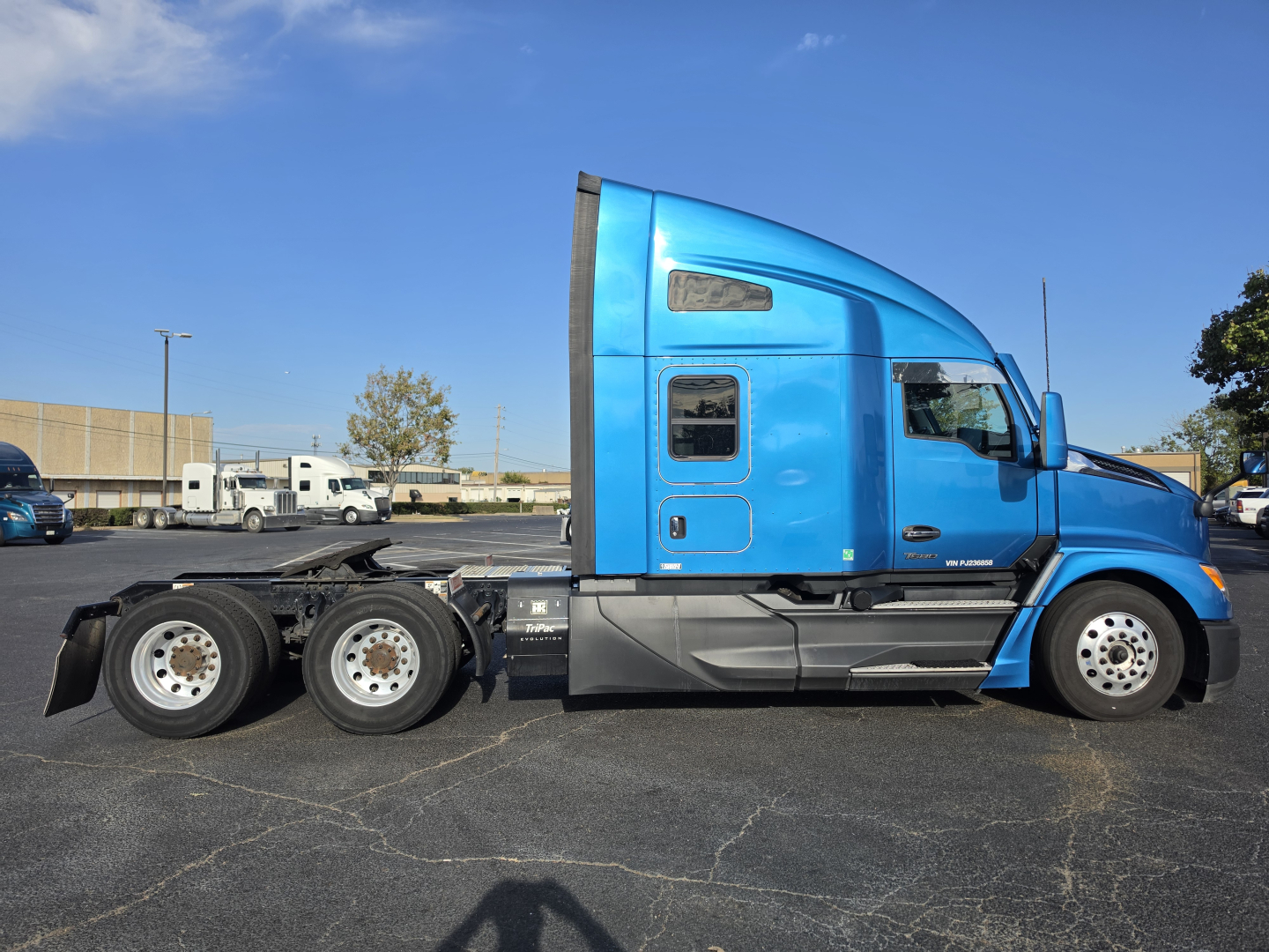 Kenworth T680 blue truck side profile showing cab and rear chassis with multiple axles.