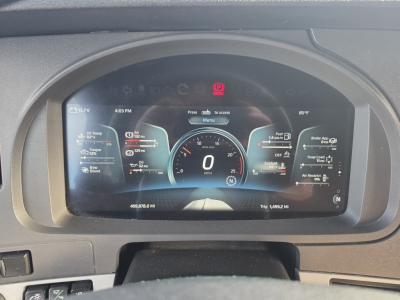 Kenworth T680 instrument cluster display showing digital gauges and Vehicle Information; 0 miles, 0 speed, various status indicators on the dash.
