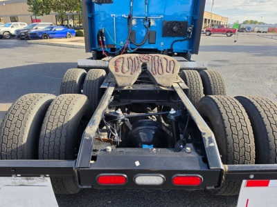 Dual rear axles and fifth wheel hitch on a used Kenworth T680 tractor showing tire configuration and rear chassis components.