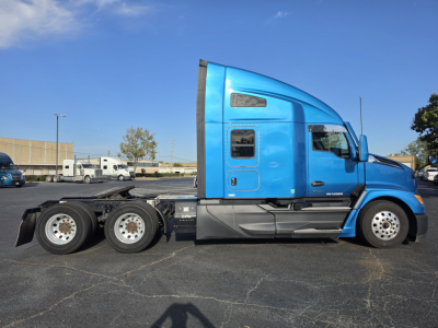 Kenworth T680 blue truck side profile showing cab and rear chassis with multiple axles.
