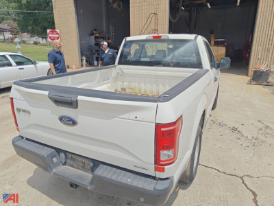 Ford F-150 pickup truck rear view showing bed and tailgate with Ford logo and taillights.
