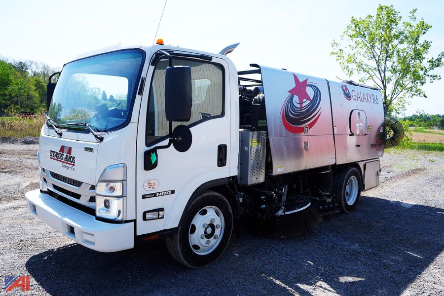 Isuzu NNR street sweeper truck in-service showing Galaxy R6 design and cleaning equipment on side panel.
