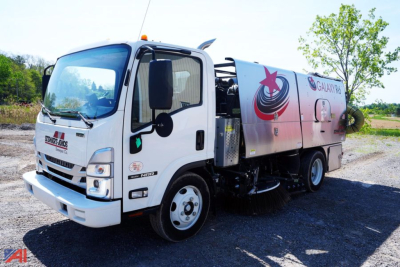 Isuzu NNR street sweeper truck in-service showing Galaxy R6 design and cleaning equipment on side panel.