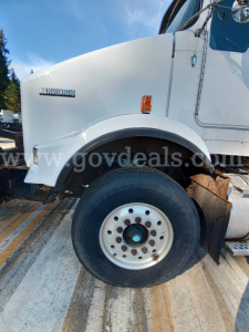 Kenworth T800B truck front wheel and fender with Kenworth badge visible.