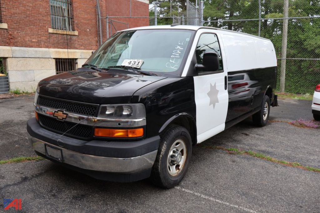 Chevrolet Express van police vehicle in a two-tone black and white paint scheme with star badge on the side, front view.