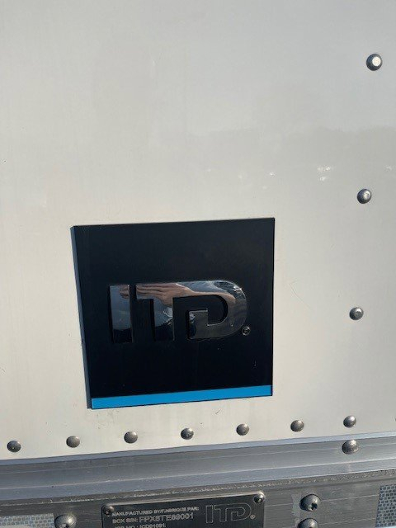 Box van truck side panel with HD logo badge and riveted metal surface.