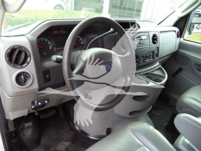 Ford E-450 cab interior showing steering wheel, dashboard, and center console with gauges and controls.