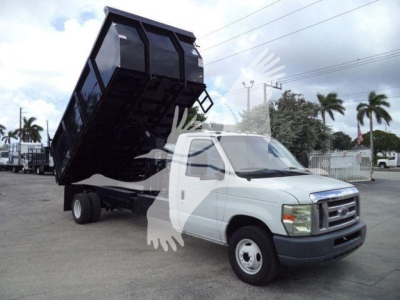 Truck cab with a raised dump bed on a Ford E-450 chassis, front view showing the lifted black dumping container