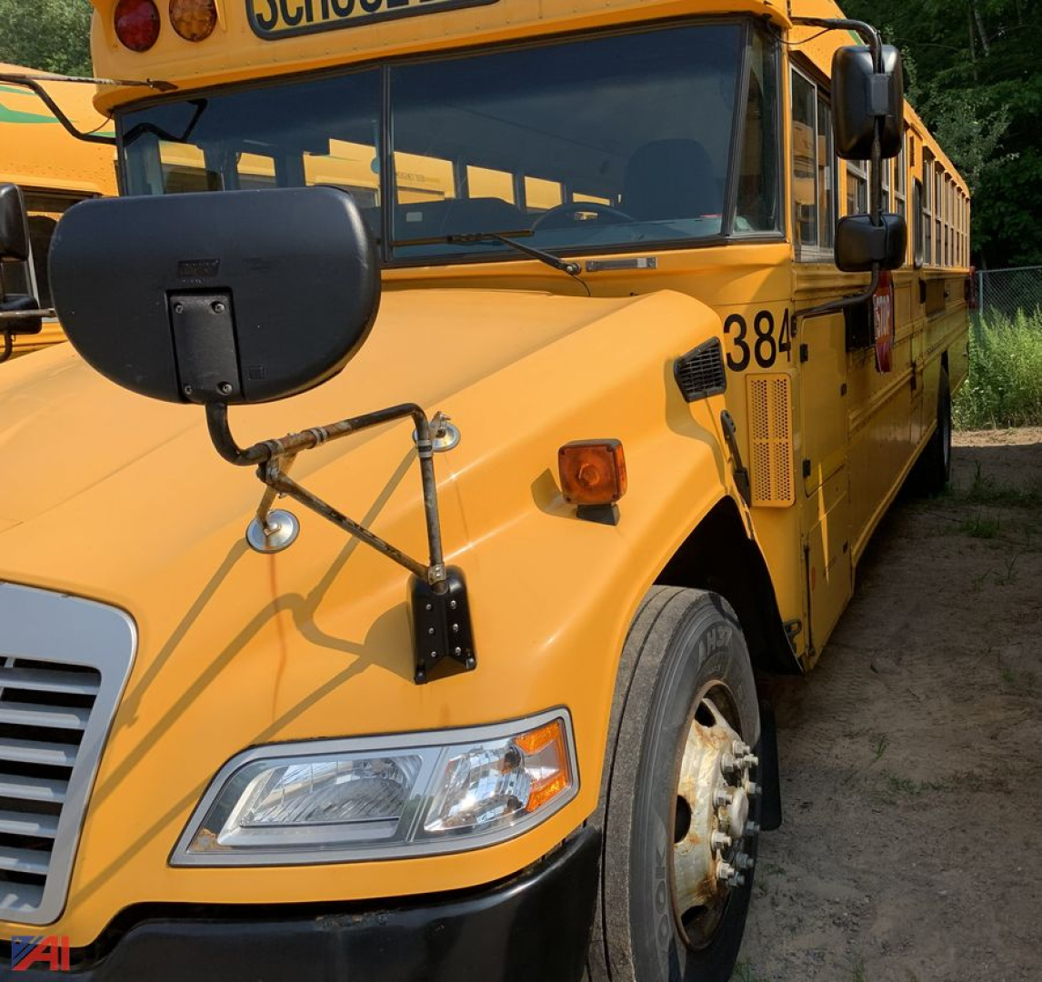 School bus front left side showing headlight, large folded mirror, orange body with bus number 38-1, blue Bird logo area, and front bumper.