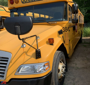 School bus front left side showing headlight, large folded mirror, orange body with bus number 38-1, blue Bird logo area, and front bumper.