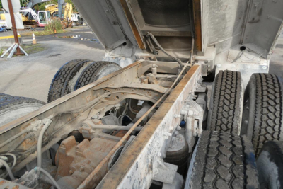 Chassis and rear undercarriage of a 2005 Mack CV Granite CV713 dump truck showing frame rails, suspension, air lines, and dual rear axles.