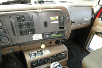 Mack CV Granite truck interior dashboard showing controls and CD radio unit.