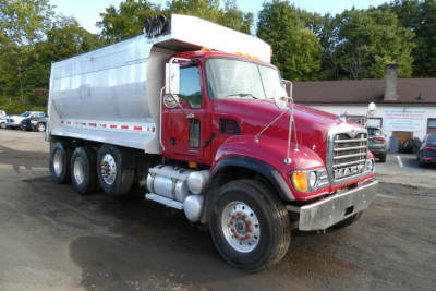 Mack CV Granite dump truck 2005 CV713 with red cab and silver dump body, front grille, headlights, and dual rear wheels.