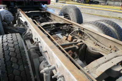 Chassis of a 2005 Mack CV Granite CV713 dump truck showing frame rails, suspension, and rear wheels.