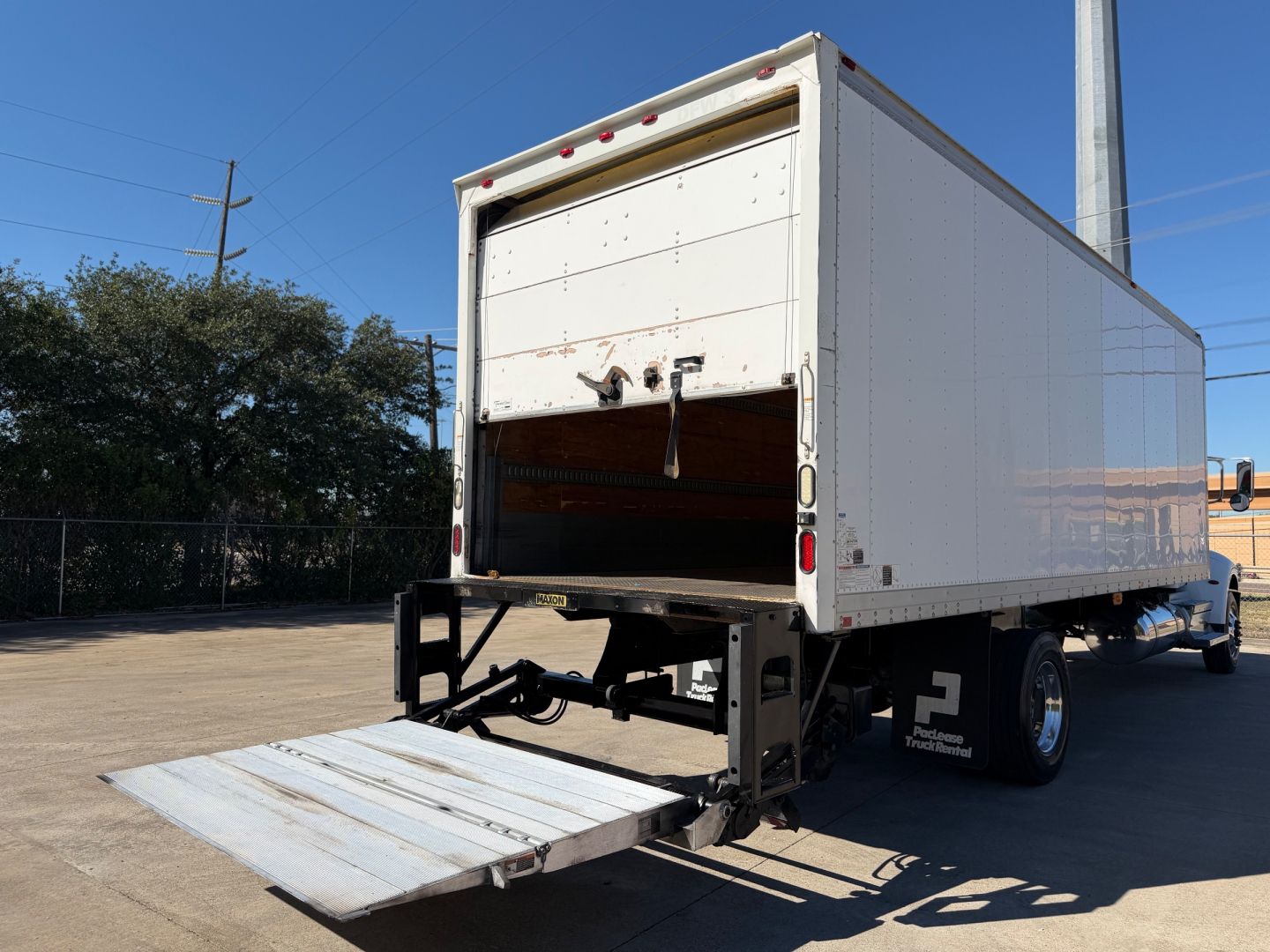 Peterbilt 337 box truck rear with liftgate open showing cargo area and rear bumper.
