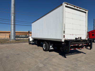 Peterbilt 337 box truck with cargo trailer rear view showing white box and black undercarriage.
