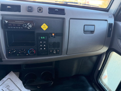 Peterbilt 337 driver dashboard panel showing climate controls and gear selector in view.