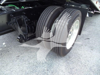 Dual rear wheels and suspension of a new International truck chassis with visible tires and frame.
