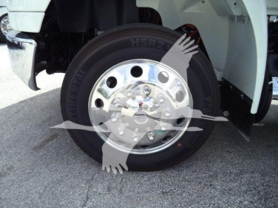 Truck wheel and tire with polished chrome hub showing HSR2 tire branding and wheel bolts; surrounding white fender and chassis visible.