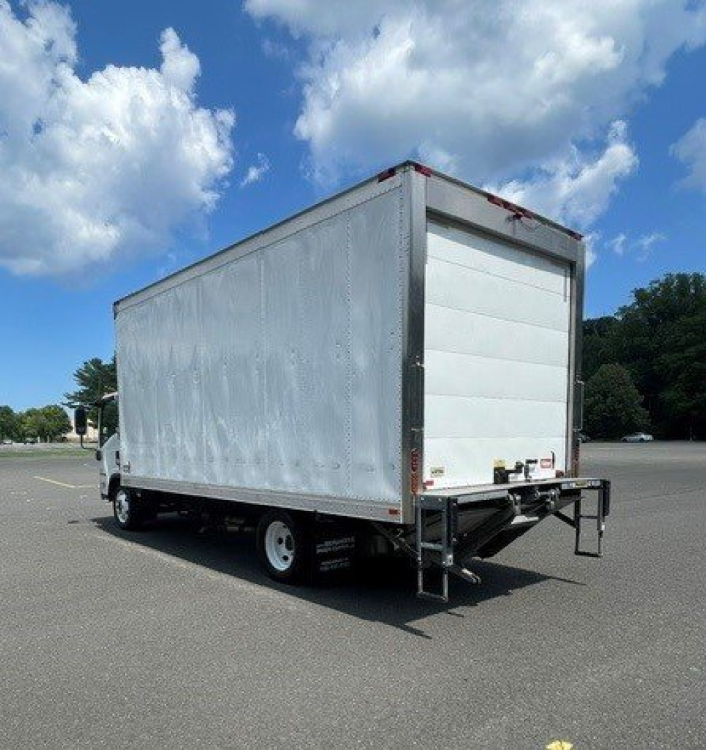 Isuzu NQR box truck rear and side view showing cargo box and rear roll-up door, white exterior, chassis with dual rear wheels.