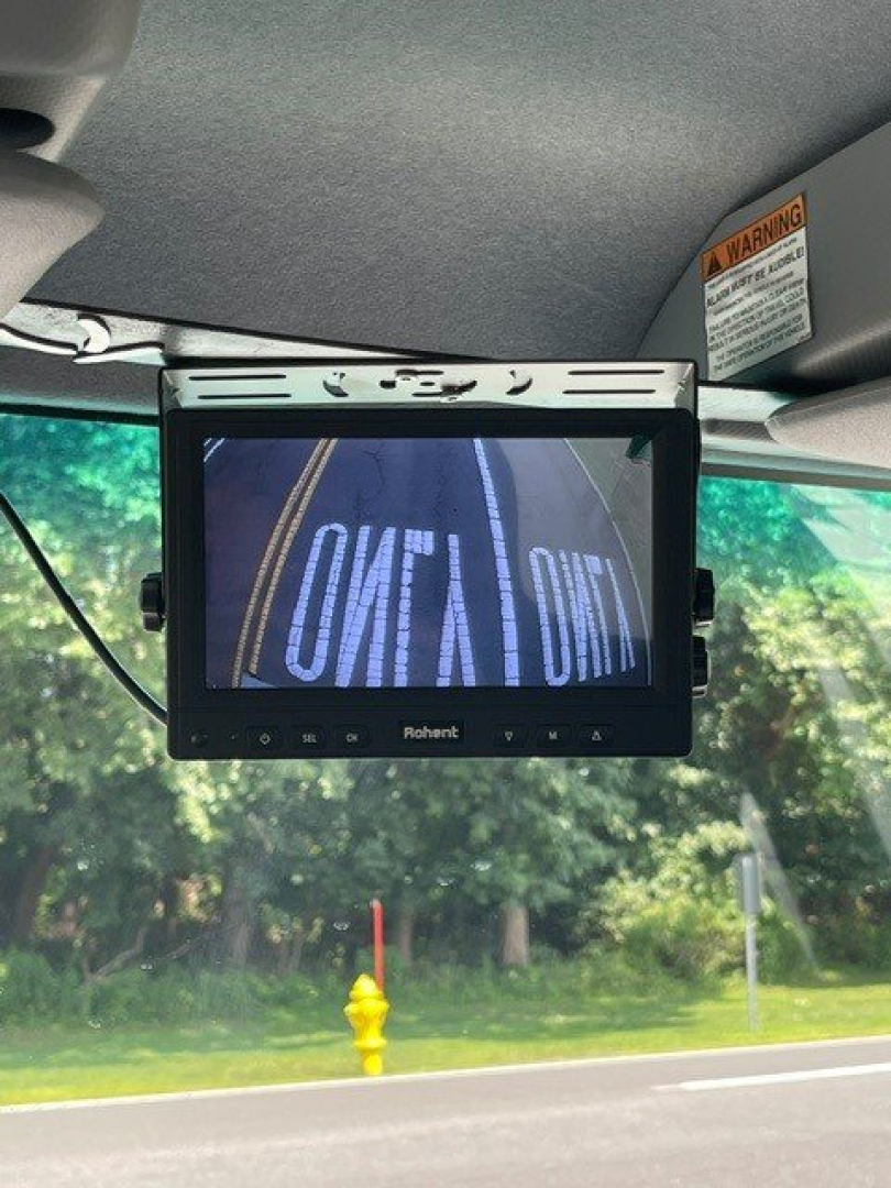 Isuzu NQR interior dash area with a Rohent / Rhonet(?) screen mounted; visible text on screen reads 'SOFT