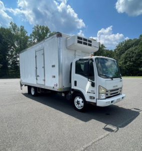 Isuzu NQR box truck with refrigeration unit on the cab roof, white exterior, side door, in a parking lot.