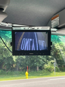 Isuzu NQR interior dash area with a Rohent / Rhonet(?) screen mounted; visible text on screen reads 'SOFT