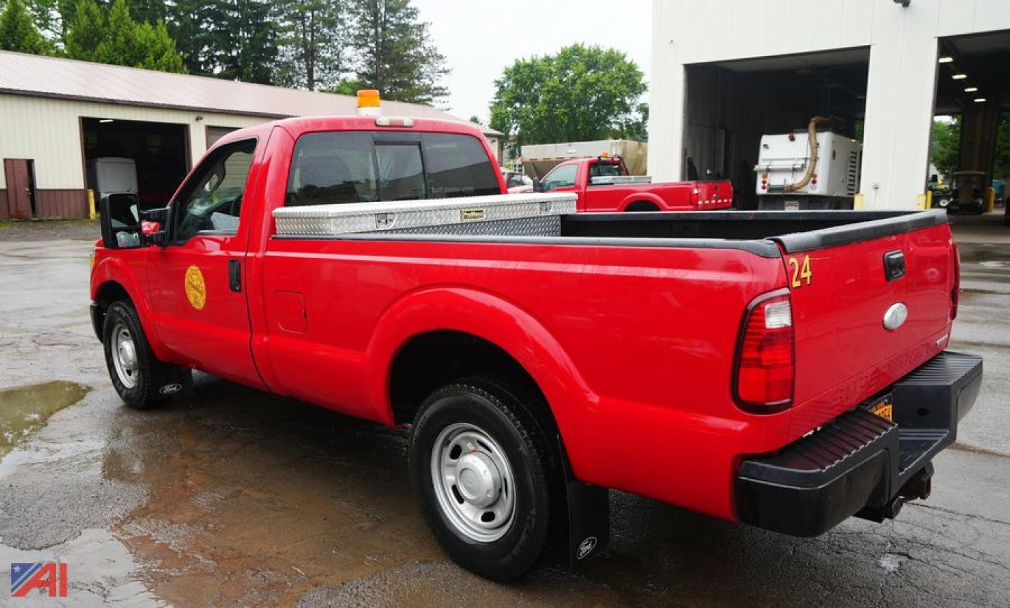 2012 Ford F250 SD XL pickup truck with toolbox in red, side rear view showing bed and toolbox, two-wheel drive.