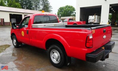 2012 Ford F250 SD XL pickup truck with toolbox in red, side rear view showing bed and toolbox, two-wheel drive.