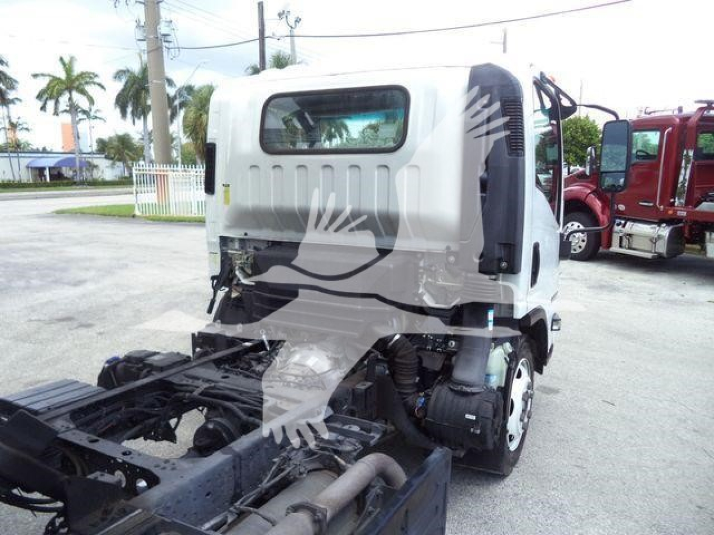 Isuzu NPR XDi cab and chassis showing rear cabin with window, side mirrors, and exposed chassis; no visible text on panels.