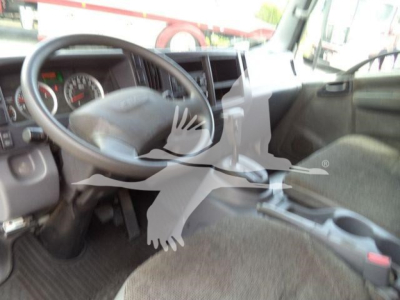 Isuzu NPR XD truck cabin interior with steering wheel and dashboard view.