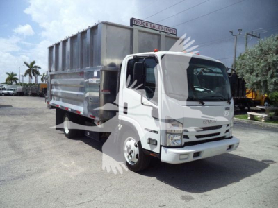 Isuzu NPR XD dump truck in service showing cab and dump bed with silver body and white cab, front view.