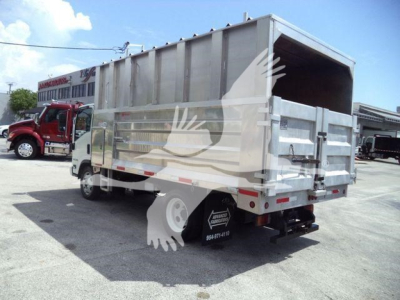 Isuzu NPR/XD truck with a gray dump bed viewed from rear-left side showing cargo bed and tailgate.