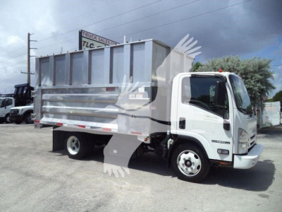 Isuzu NPR XD dump truck side view showing dump bed and cab in a used condition.