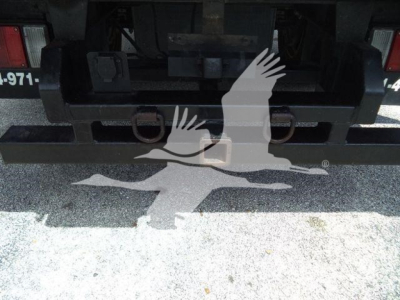 Rear view of Isuzu NPR XD chassis showing hitch and bumper with some identification numbers imparted.