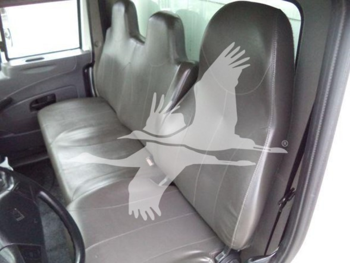 Truck cab interior showing front bench seat and passenger seat of a 2019 International Durastar 4300; watermark across seats.