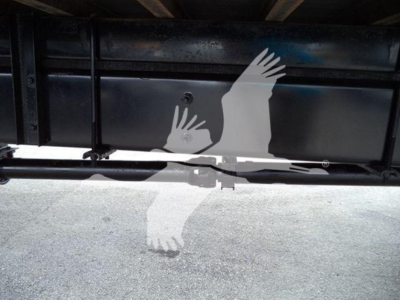 Truck undercarriage showing metal frame and hitch area with a silhouette watermark overlaid