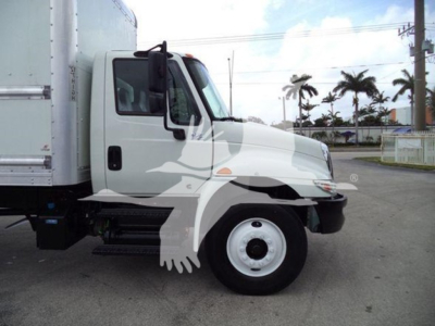 International Durastar 4300 box truck side view showing cab and front wheel. Visible text on sticker area near door and chrome bumper not legible.
