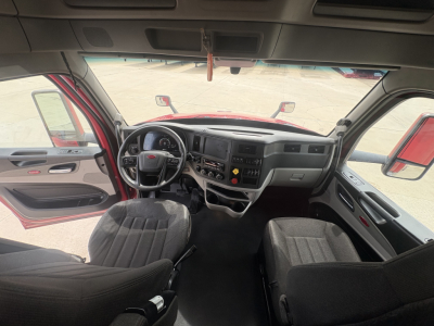 Peterbilt 579 truck interior view with dashboard, steering wheel, and two front seats.