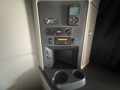 Interior panel of a 2023 Peterbilt 579 driver console showing control gauges and stereo unit.