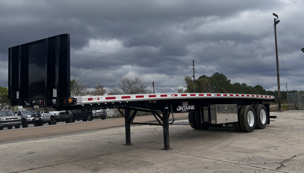 Flatbed trailer with slide-out ramps and dual rear axles, Fontaine branding visible, long combination trailer for-frk lift kit setup.