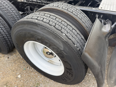 Dual rear axle tires on a 2019 International LT truck with white steel wheel, rubber tread, and mudguard visible.