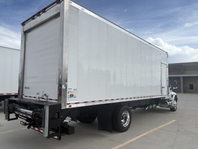 Truck trailer side and rear showing a white refrigerated box on a cab chassis, with no visible branding text legible.