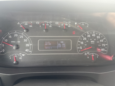 Dashboard of a 2021 International MV607 showing gauges and central digital display with miles 287,765 and voltage 14.1V.