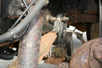 Mack CH612 truck undercarriage showing rusted frame and steering linkage components.
