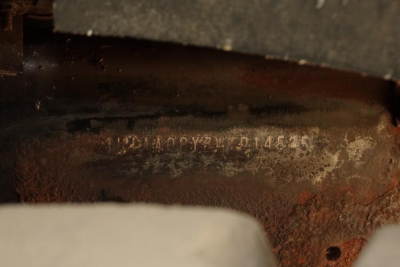 Mack CH612 engine area showing stamped VIN/ID number on rusty surface, partial view of engine bay with low lighting.
