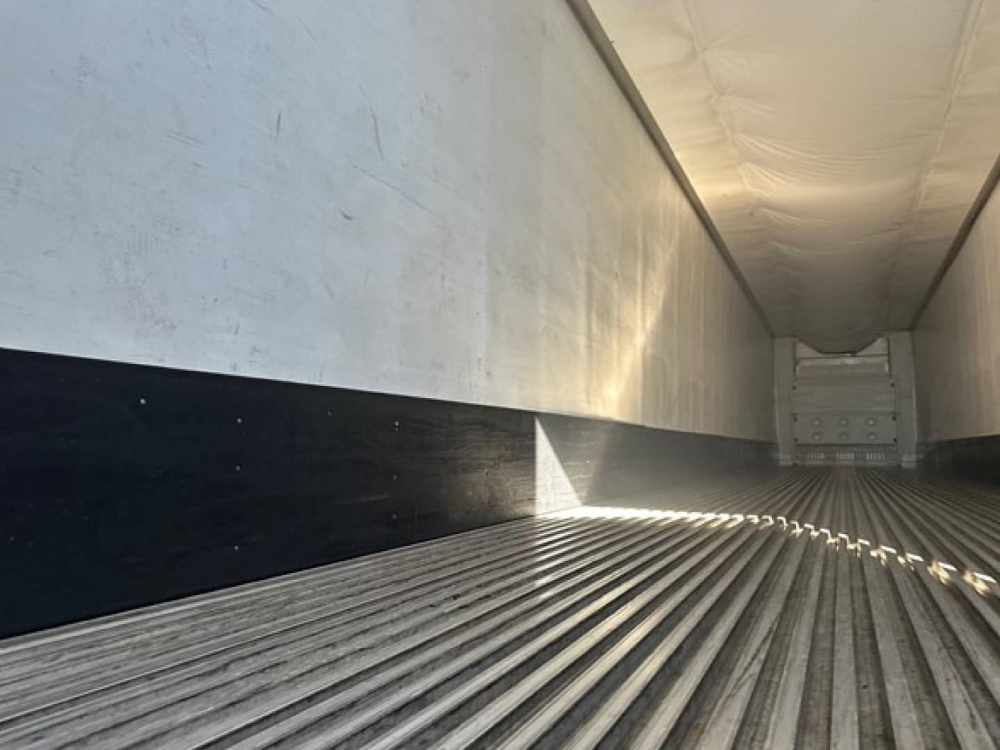 Trailer interior showing ribbed metal floor and side walls of a 2019 Utility 3000R reefer trailer, empty cargo area.