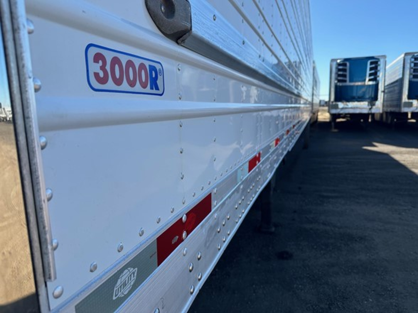 Trailer side showing 3000R logo and riveted aluminum wall with reflectors.