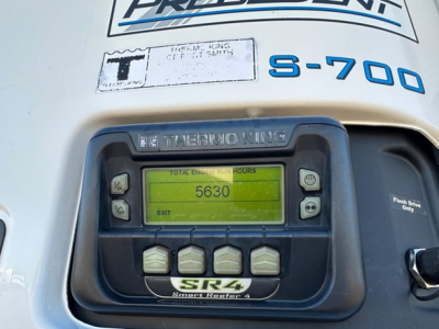 Thermo King SR4 unit on a Utility 3000R trailer showing display with 5630 total engine hours and buttons; S-700 label nearby.